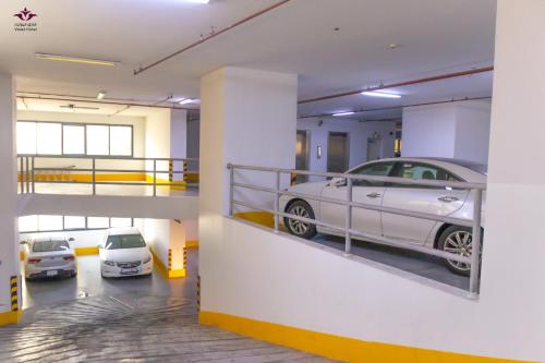 a car garage with two cars parked in it at Violet Al Azizia Hotel MASJID Al Qatari in Makkah