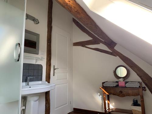 a bathroom with a sink and a mirror at La Glatine - Chambres d'hôtes in Frétigny