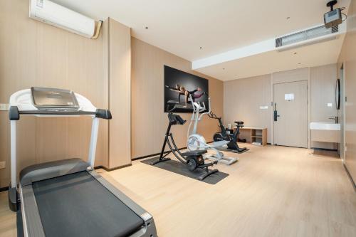 a room with a gym with exercise bikes in it at Relax Hotel - Shenzhen Bao'an International Airport in Bao'an