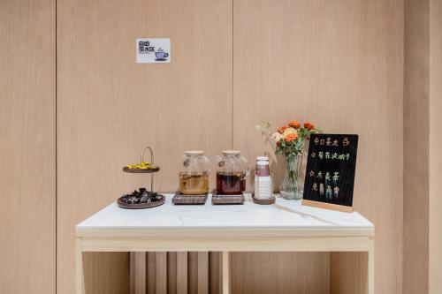 a table with two glass jars on top of it at Relax Hotel - Shenzhen Bao'an International Airport in Bao'an