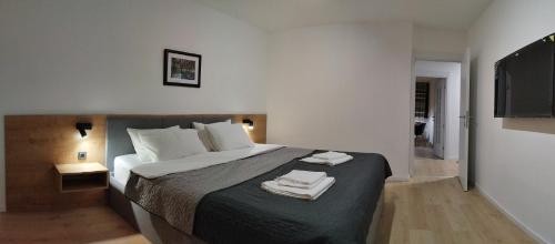 1 dormitorio con 1 cama con 2 toallas en Home apartment, en Niš