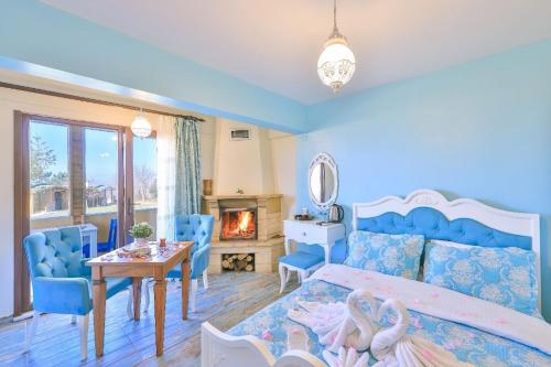 a bedroom with a bed and a table and a fireplace at Agva Teras Garden Hotel & Bungalow in Agva