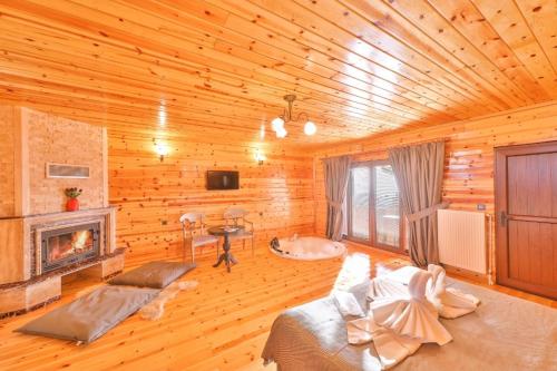 a log cabin room with a fireplace and a bed at Agva Teras Garden Hotel & Bungalow in Agva
