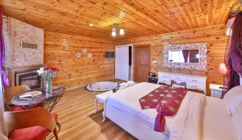 a bedroom with a bed and a table in a room at Agva Teras Garden Hotel & Bungalow in Agva