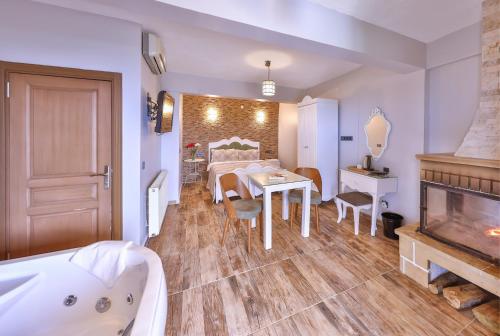 a bathroom with a tub and a table and a bedroom at Agva Teras Garden Hotel & Bungalow in Agva