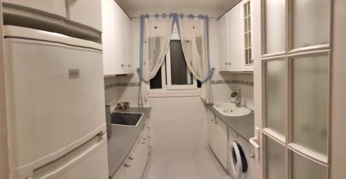 a white bathroom with a sink and a mirror at APARTAMENTO PUERTO GOLF in Almerimar