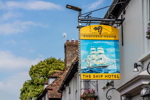 a sign for the ship hotel hanging on a building at The Ship Hotel in New Romney