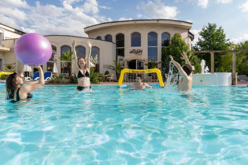 a group of people playing in a swimming pool at Hotel Azzun Orient SPA&Wellness in Kromerowo