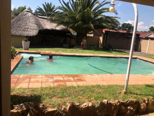 a person swimming in a swimming pool at Garden View Guesthouse Fleurhof in Johannesburg
