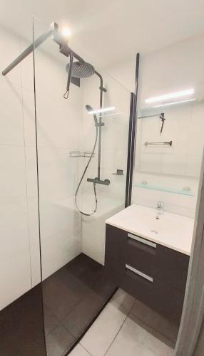 a bathroom with a shower and a sink at Studio met zeezicht in Blankenberge