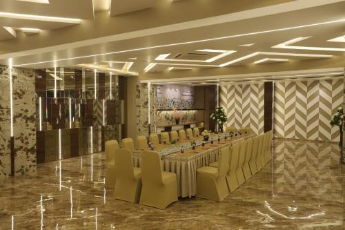 a conference room with a long table and chairs at Hotel Auris & Banquets, Mumbai International Airport in Mumbai