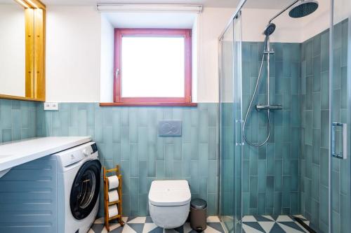 a bathroom with a shower and a washing machine at Apartment 12 - U Pivovaru Boží Dar - electric car charger in Boží Dar