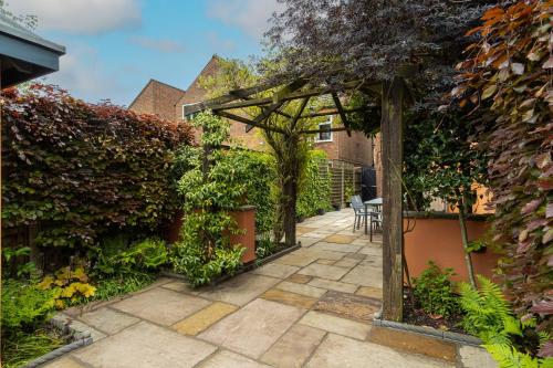 a garden with a pergola and a patio at Ellistown Retreat in Hugglescote