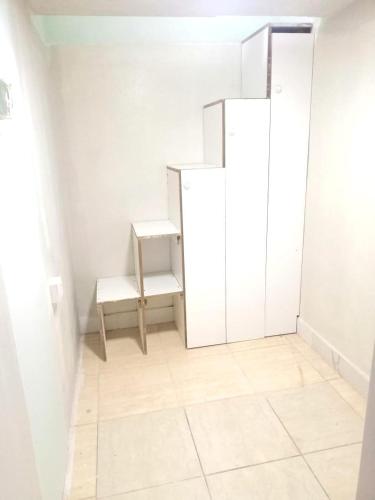 a small room with a white closet and a bench at Partition available 2 minutes away from Rigga metro Asians Only in Dubai