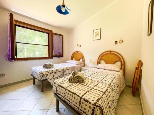 - une chambre avec 2 lits et une fenêtre dans l'établissement Torre di Chia Holiday Home, à Chia