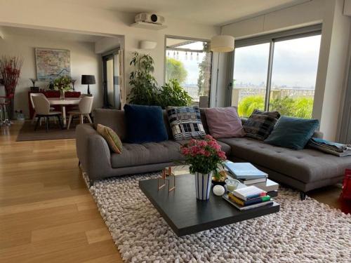 un salon avec un canapé et une table dans l'établissement Magnificent Penthouse panaramic view of Paris, à Paris