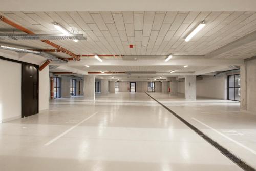 an empty hall with white floors and ceilings at Apartments Svitnjak in Bovec