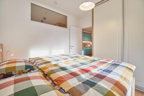 two beds in a room with white walls at Apartments Svitnjak in Bovec