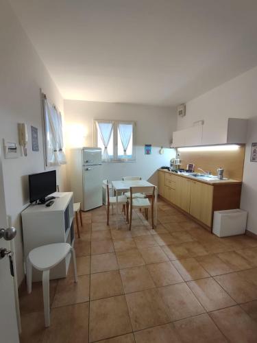 a kitchen with a table and chairs and a table and a kitchen with a counter at Nice apartments lake view & free parking in Pastrengo