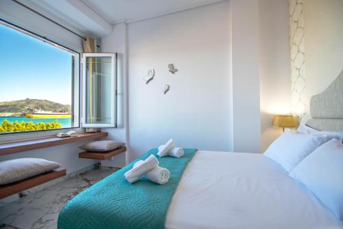 a bedroom with a bed with towels on it at Zante Harbour Suites with free gym services by "elite" in Zakynthos Town