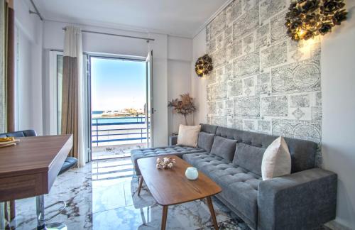 a living room with a couch and a table at Zante Harbour Suites with free gym services by "elite" in Zakynthos Town