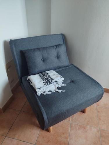 a blue chair with a pillow on top of it at Nice apartments lake view & free parking in Pastrengo