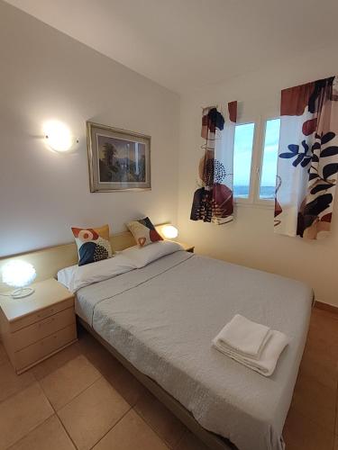 a bedroom with a large bed with two lights on at Nice apartments lake view & free parking in Pastrengo