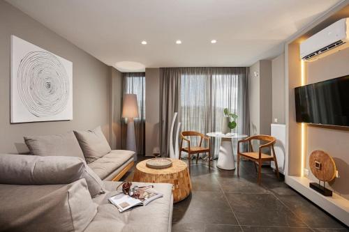 a living room with a couch and a table at CW Athens Riviera Suite in Athens