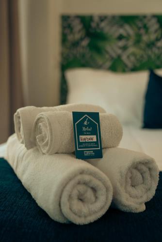 a pile of towels sitting on top of a bed at Sucre Suites in Buenos Aires