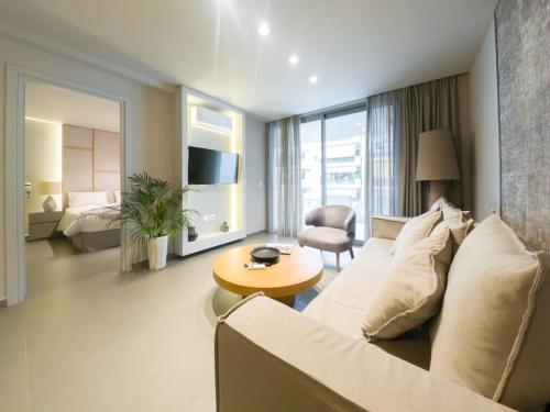 a living room with a couch and a table at CW Athens Riviera Suite in Athens