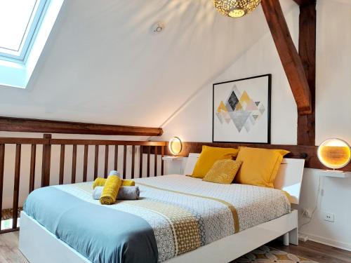 a bedroom with a bed with yellow pillows at Yellow Home-by So'SerenityHome-balcon vue montagne-mezzanine in Cluses