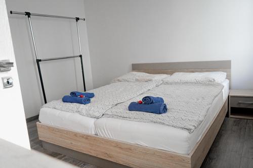 a bedroom with a bed with blue pillows on it at Apartmán u Martina in Žilina