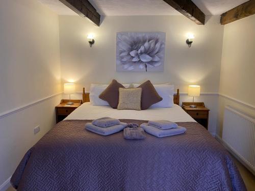 a bedroom with a bed with two towels on it at Bryn Melyn Farm Cottages in Bala