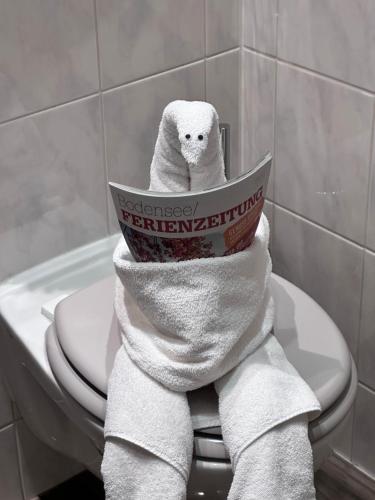 a pile of towels on a toilet in a bathroom at Hotel Sonne in Weingarten