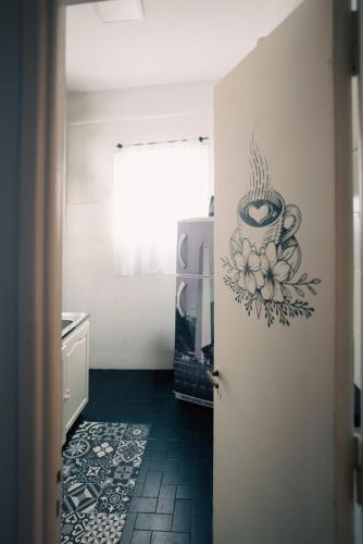a kitchen with a door with a painting of a coffee cup at Sucre Suites in Buenos Aires