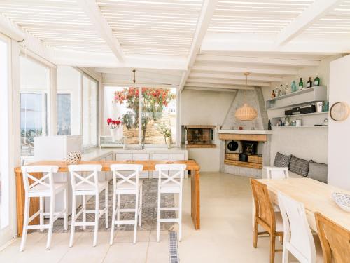 a kitchen with a table and chairs in a room at Delfini Villas 1, 2, 3, 4, 5, 6 - Kalamaki in Kalamaki