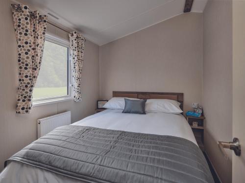a bedroom with a bed and a window at Seaton Estate in Arbroath