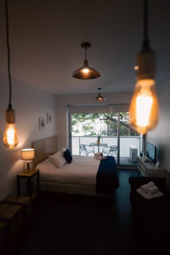 a bedroom with a bed with a view of a balcony at Sucre Suites in Buenos Aires