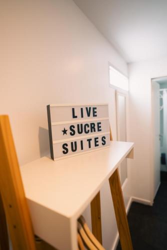 a sign that says live super suites on a table at Sucre Suites in Buenos Aires