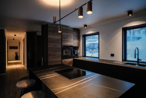 a kitchen with a black counter and a sink at Botnahlid Villa in Seyðisfjörður