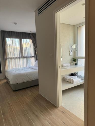 a bedroom with a bed and a mirror at Allenbeach TLV- apart Hotel- Adults only in Tel Aviv