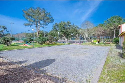 an empty parking lot with a park in the background at Villa ROMA in Soustons