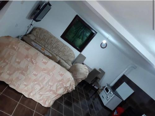 a bedroom with a bed and a flat screen tv at Veskov Konak in Andrijevica