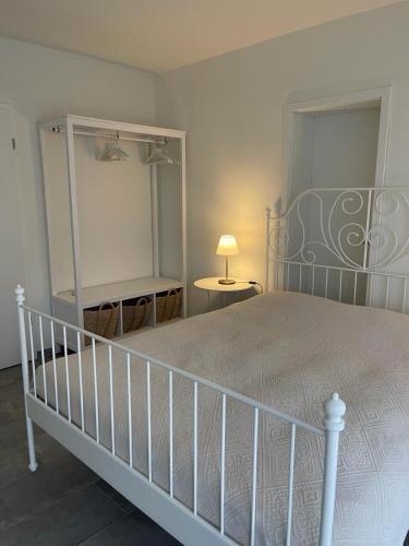 a bedroom with a large bed and a table with a lamp at Minusio-Locarno Casa al Lago 2 in Minusio