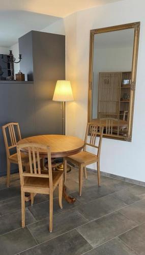 a dining room table with two chairs and a mirror at Minusio-Locarno Casa al Lago 2 in Minusio