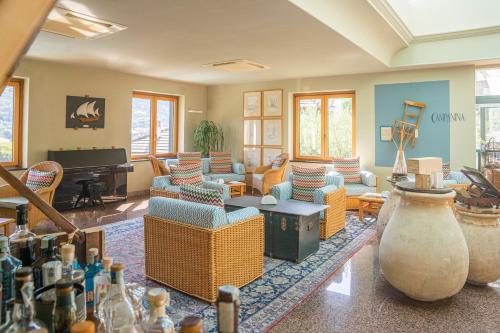 ein Wohnzimmer mit Sofas und einem Klavier in der Unterkunft Hotel Villa Edera & La Torretta in Moneglia