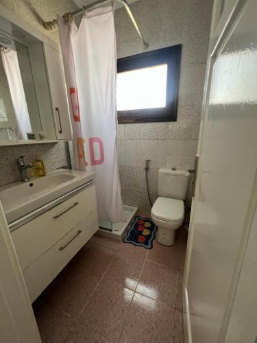 a bathroom with a toilet and a sink and a window at Delta sharm in Sharm El Sheikh