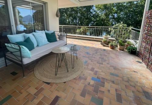a patio with a couch and a table at Minusio-Locarno Casa al Lago 2 in Minusio