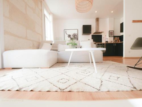 un salon avec un canapé blanc et une table dans l'établissement Le créateur - Cœur de ville, à Montpellier