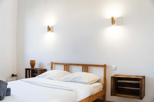 a bedroom with a bed and two lights on the wall at Grand appartement Familiale - Camargue in Salin-de-Giraud